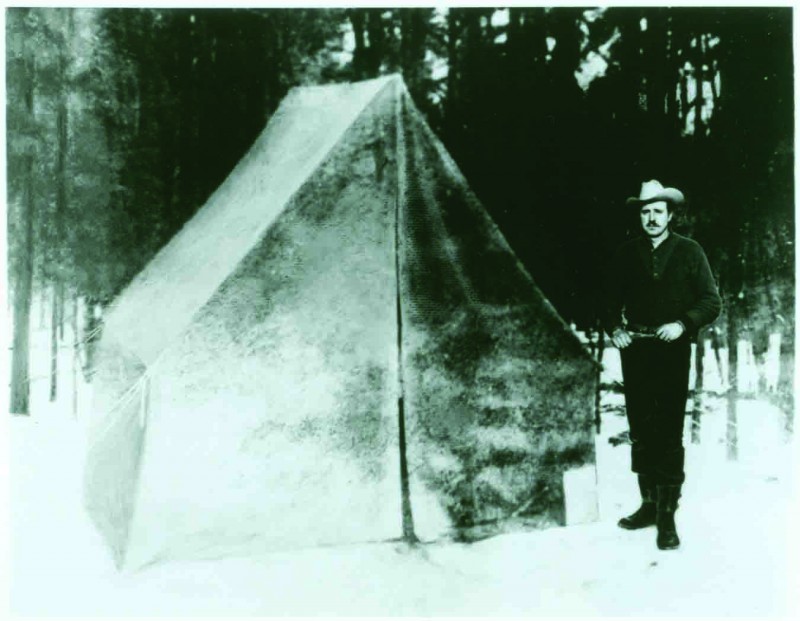 Korczak standing next to his tent